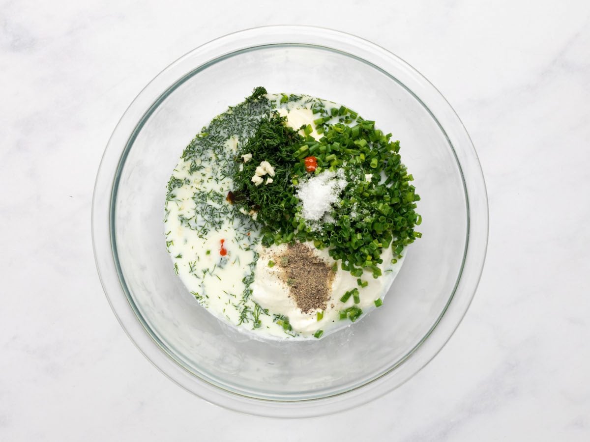 ingredients for buttermilk ranch dressing in mixing bowl.
