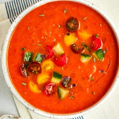 roasted red pepper and tomato gazpacho garnished with diced cucumbers and tomatoes