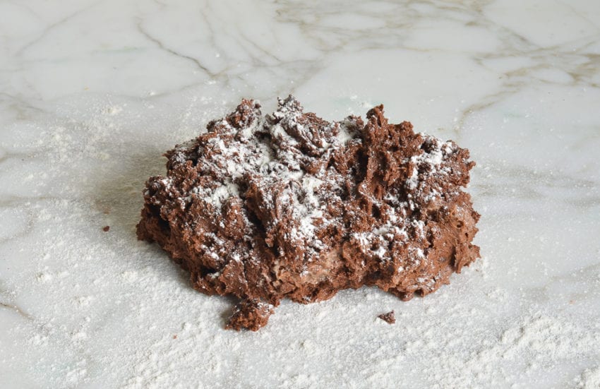 Chocolate dough on a floured counter.