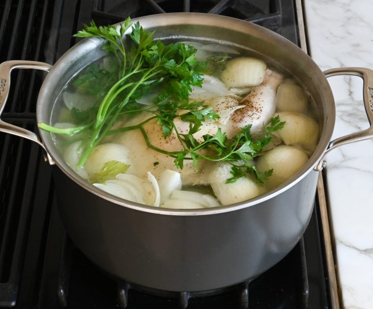 adding seasoning and parsley to the soup