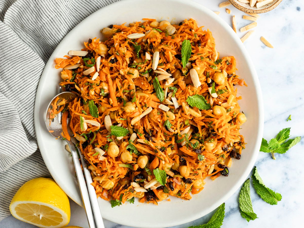 moroccan-spiced carrot and chickpea salad in white bowl.