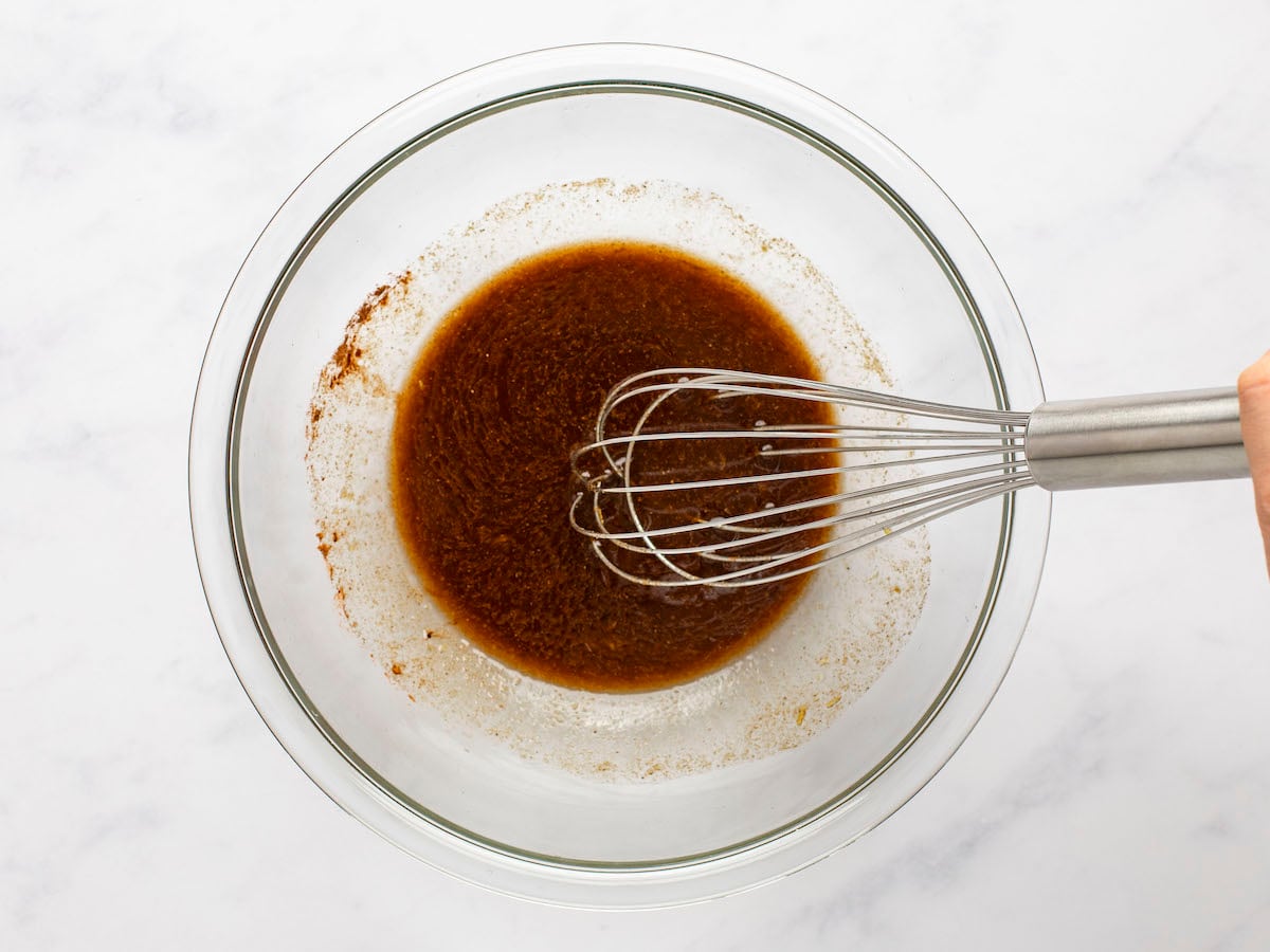 dressing ingredients whisked in mixing bowl.
