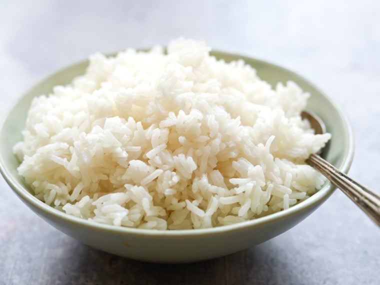 Spoon in a bowl of jasmine rice.