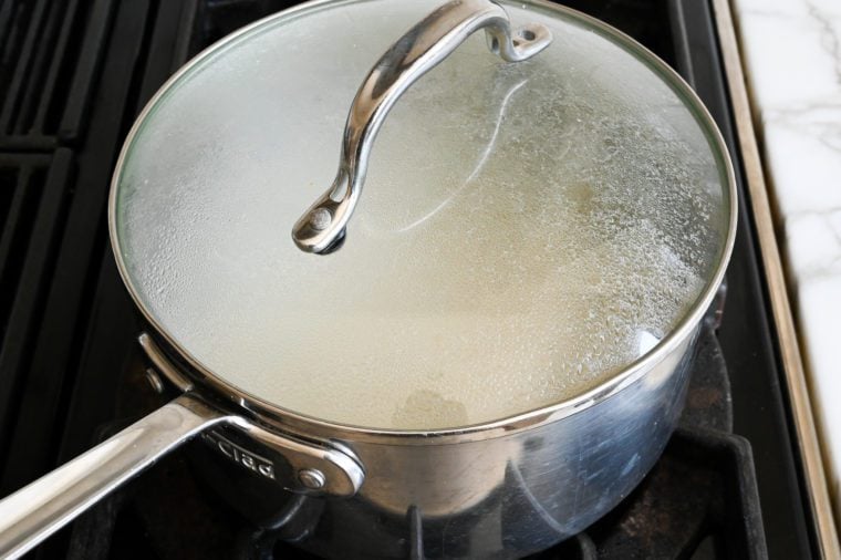 Covered pot on a stovetop.