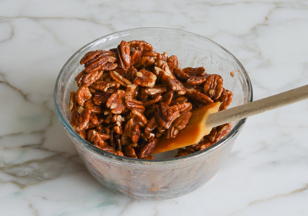 mixing the pecans with the sugar mixture