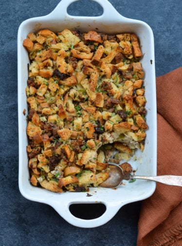 Spoon in a baking dish of sausage and herb stuffing .