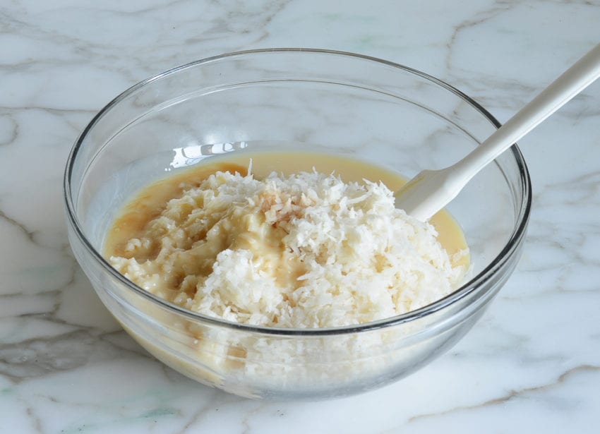 Bowl of coconut, condensed milk, and vanilla.