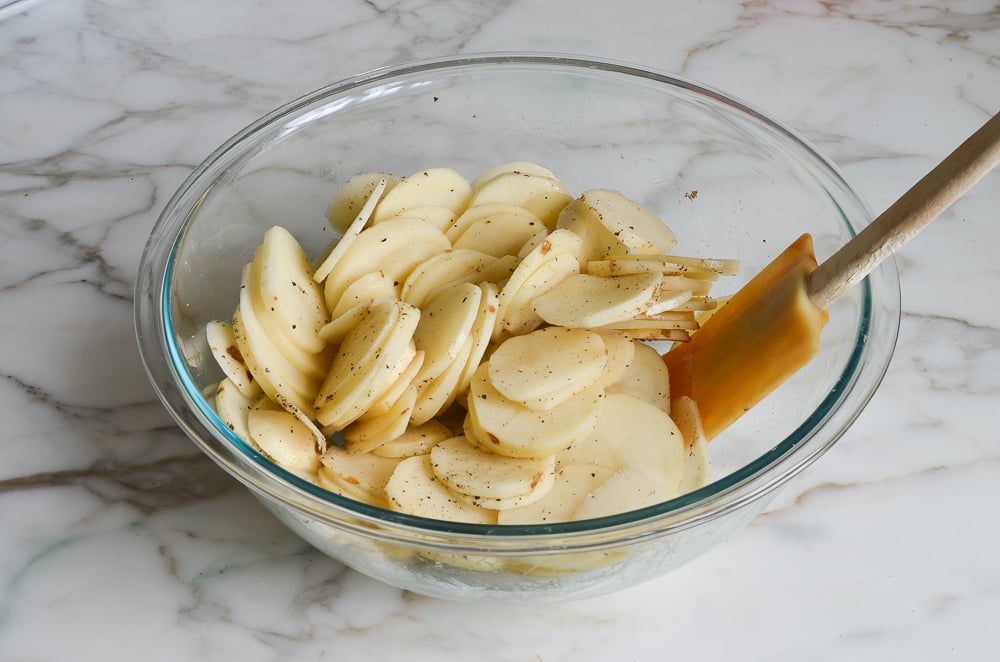 tossing potatoes with salt and pepper