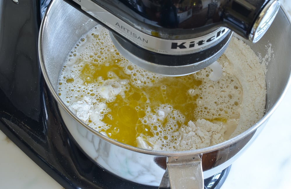 adding the warm water and the olive oil to the dry ingredients