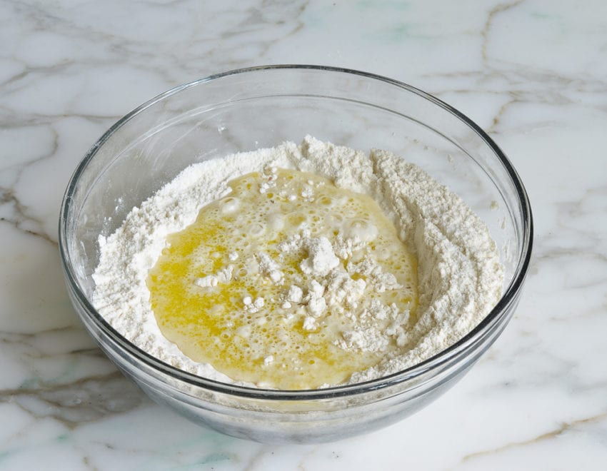 Bowl of unmixed wet and dry ingredients.