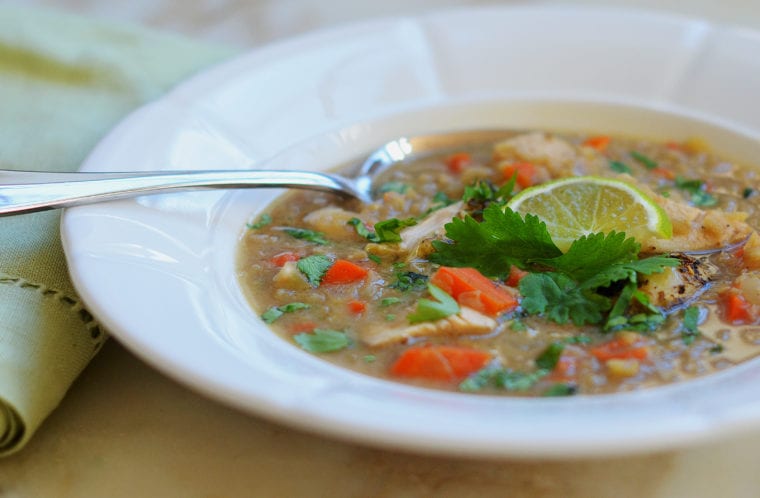 Spoon in a bowl of chicken soup.