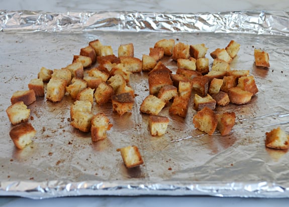 Croutons on a lined baking dish.