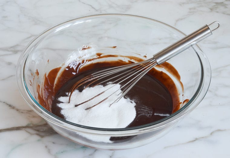 adding the sugar to the chocolate mixture