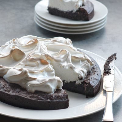 Flourless chocolate cake with meringue missing a slice.