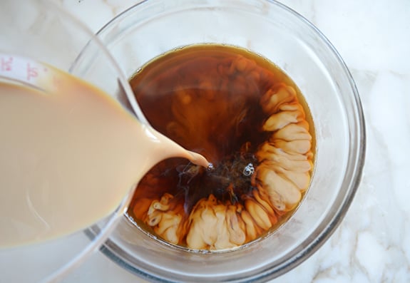 Baileys pouring into a bowl of coffee.