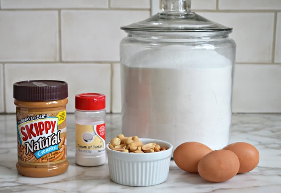 Countertop of ingredients including cream of tartar, eggs, and peanut butter.