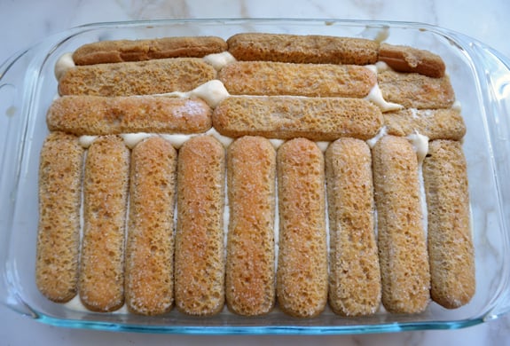 Ladyfingers in a baking dish with mascarpone cream.