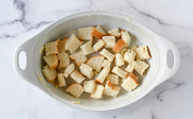 Torn bread in a baking dish.