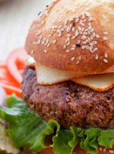 Steakhouse burger on a plate with toppings.