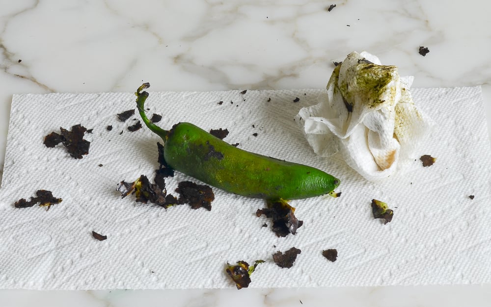 scraping the charred skin off of the jalapeno