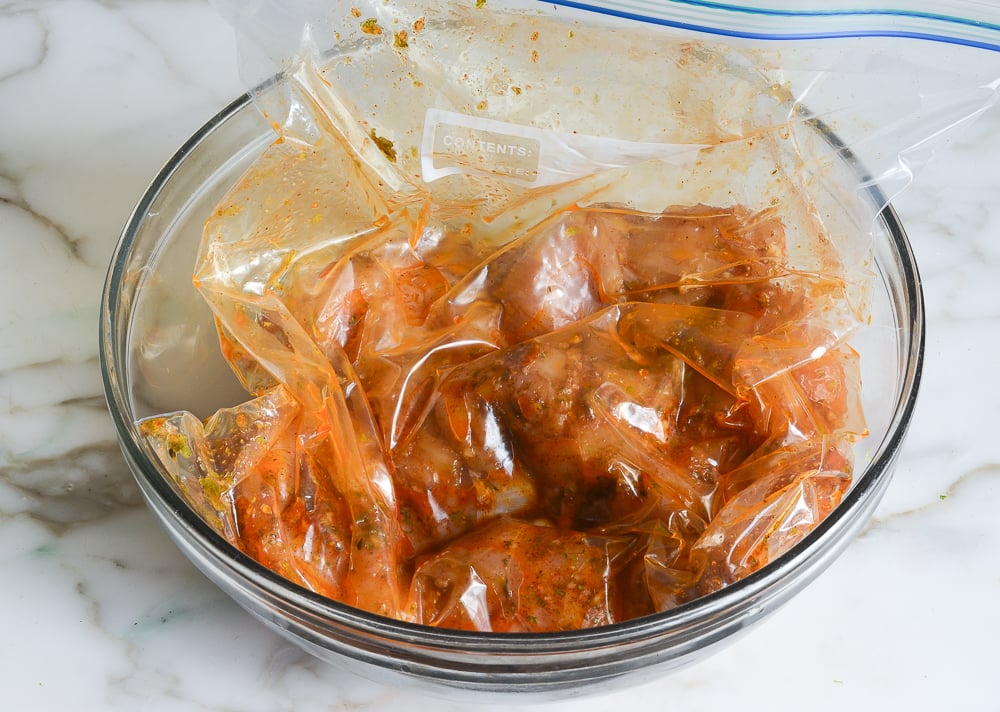 chicken marinading in bowl