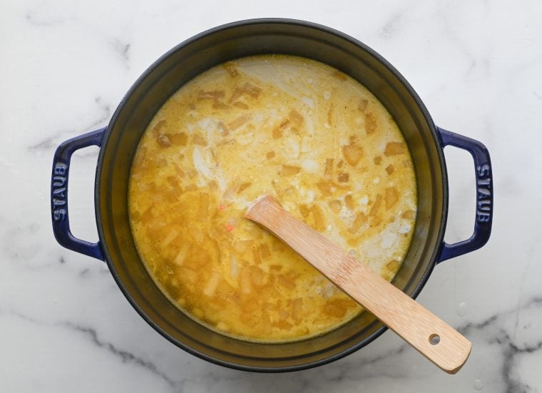 chicken broth, coconut milk, lentils, and salt added to the pot
