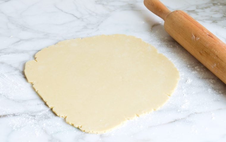 rolling out cut out sugar cookie dough