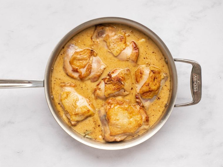chicken simmering in sauce