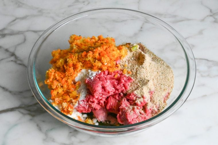 adding the meat, vegetables, bread crumbs and cheese to the egg mixture