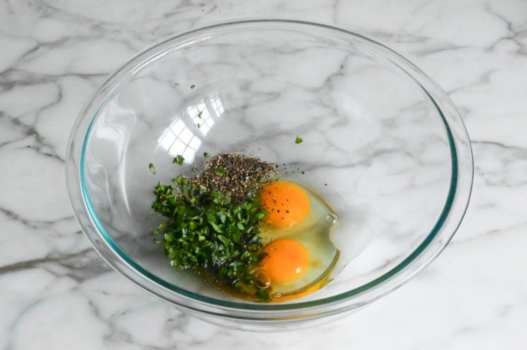 eggs, basil, Worcestershire sauce, salt and pepper in bowl