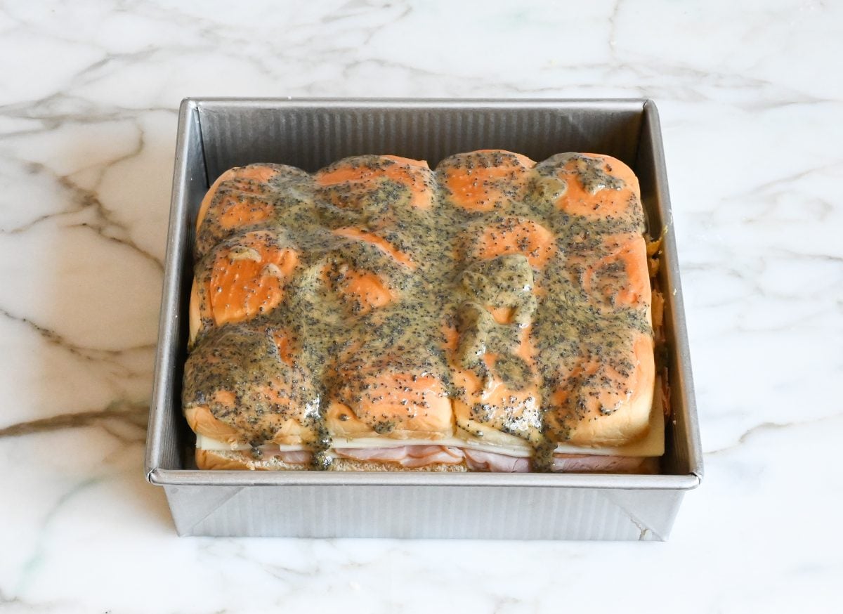 sauce spread over sliders.