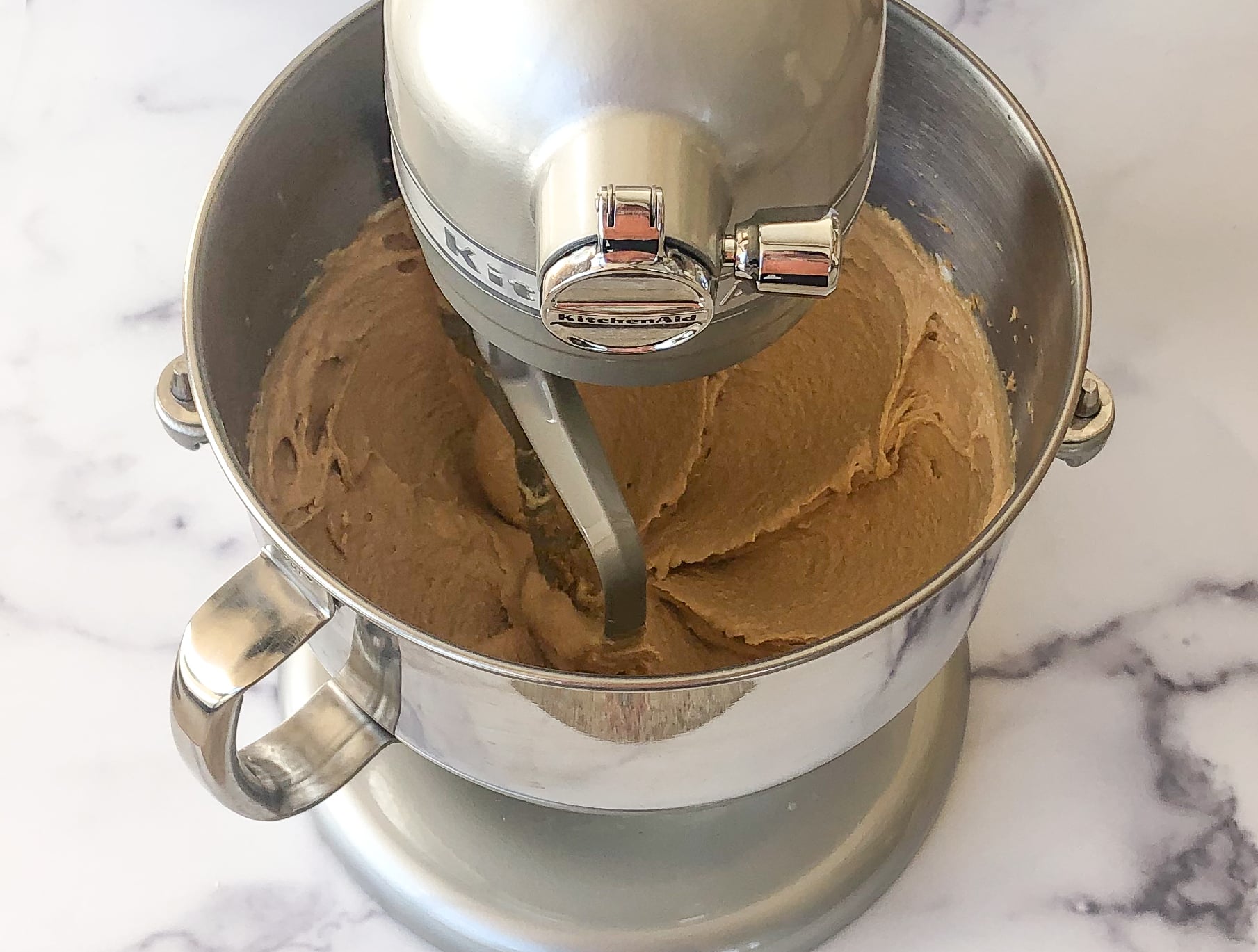 Smooth and creamy peanut butter mixture in a stand mixer.