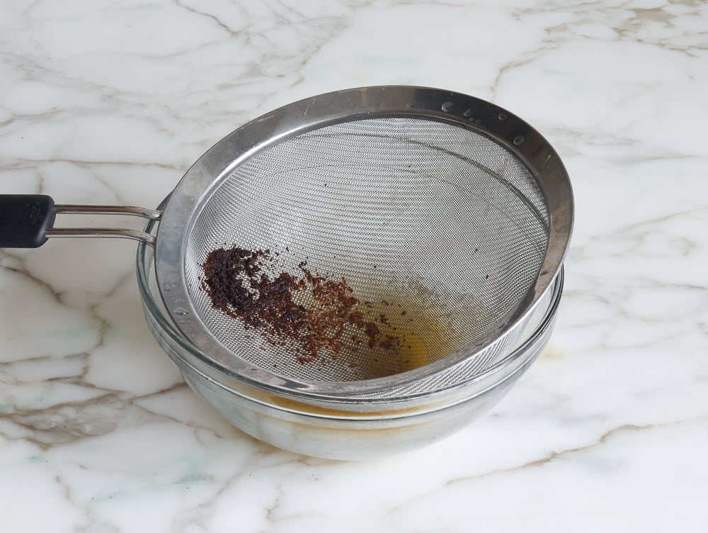 Sieve straining sediment over a bowl.