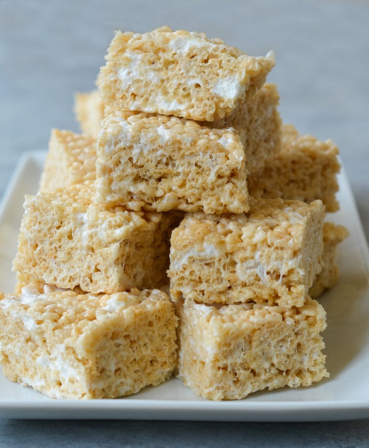 Rice Krispie treats stacked on platter from the best Rice Krispie treat recipe.
