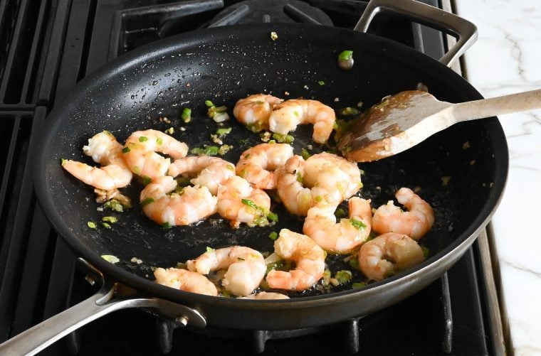 cooking the shrimp and aromatics in a skillet