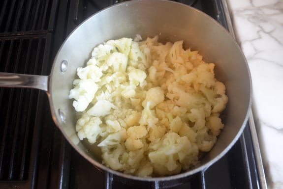 Skillet of cooked cauliflower florets.