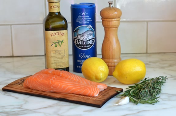 Salmon ingredients including lemon, rosemary, and garlic.