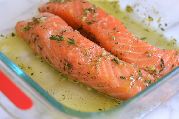 Salmon and marinade in a baking dish.