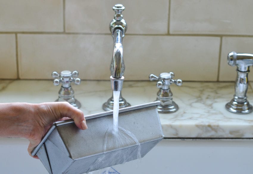 Water pouring on the side of a pan.