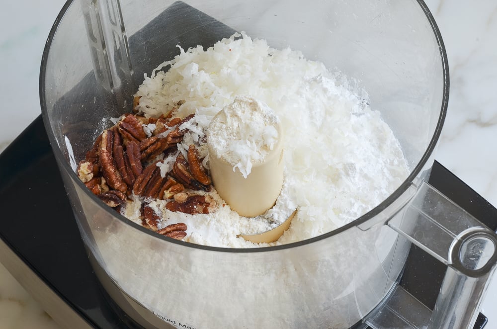 coconut, pecans, flour, sugar in bowl of food processor