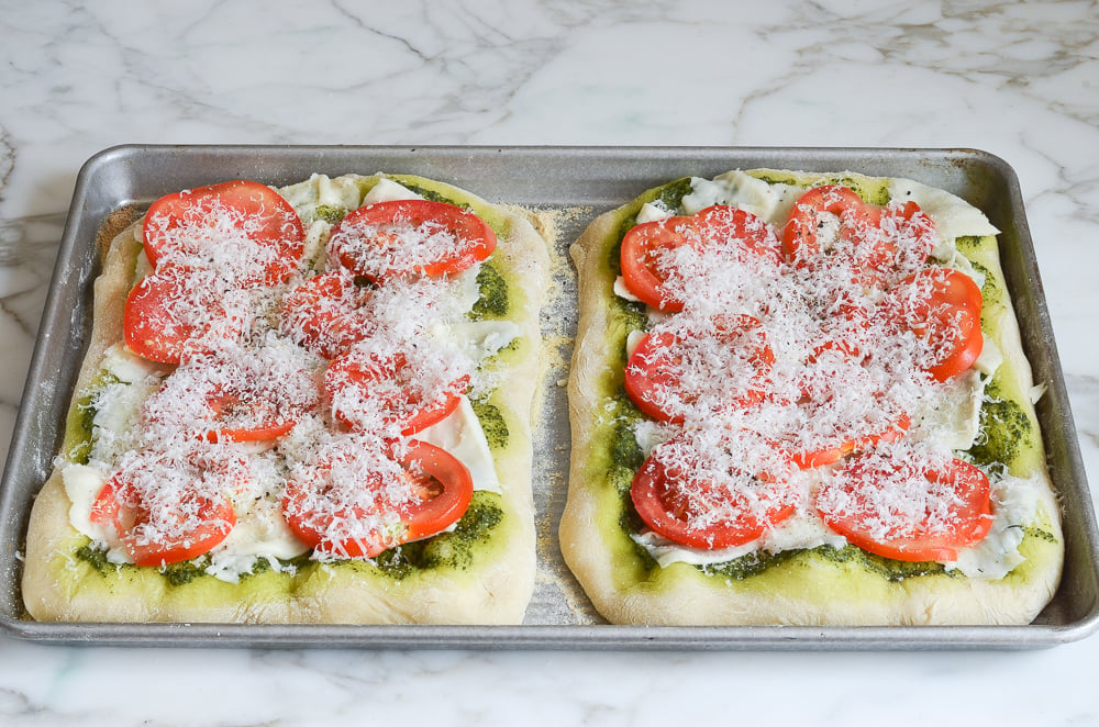 pizzas topped with cheese and tomatoes