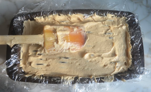 Loaf pan full of peanut butter cream.