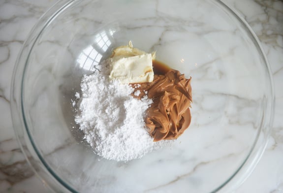 Cream cheese, peanut butter, and other ingredients in a bowl.