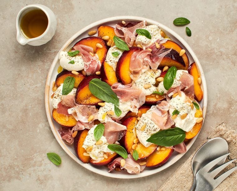Summer Peach & Burrata Salad with Prosciutto on platter