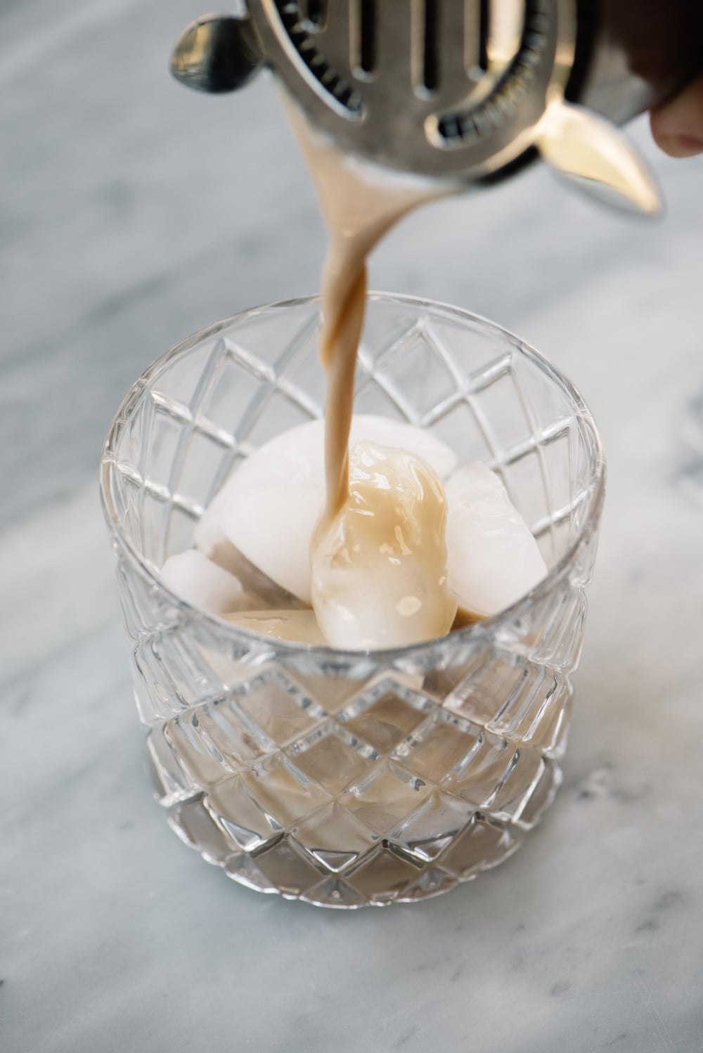 Mudslide pouring into a glass with ice.