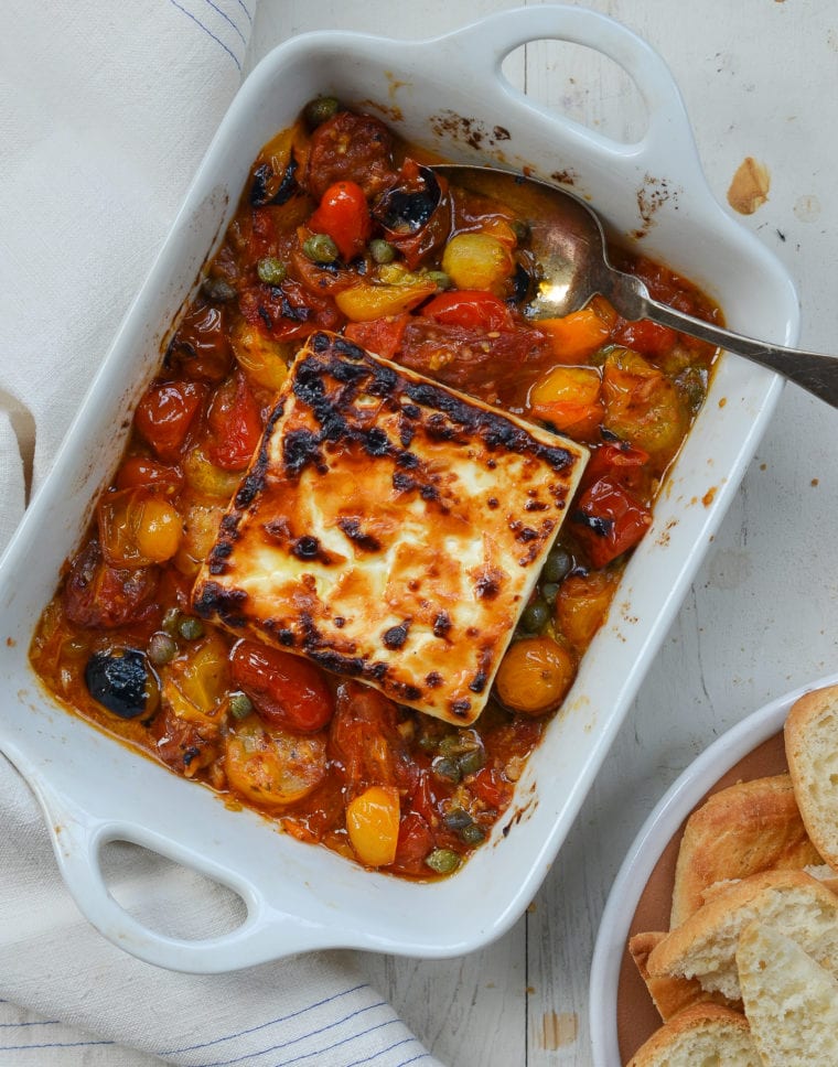 Spoon in a pan of broiled feta.