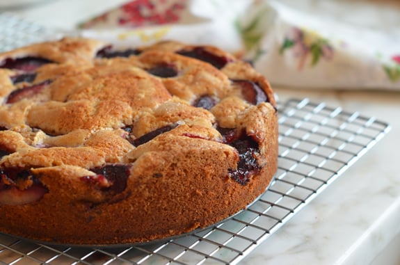 Plum cake on a wire rack.