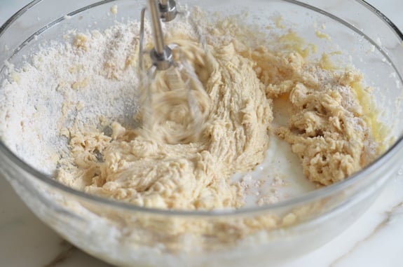 Milk added to batter in a bowl.