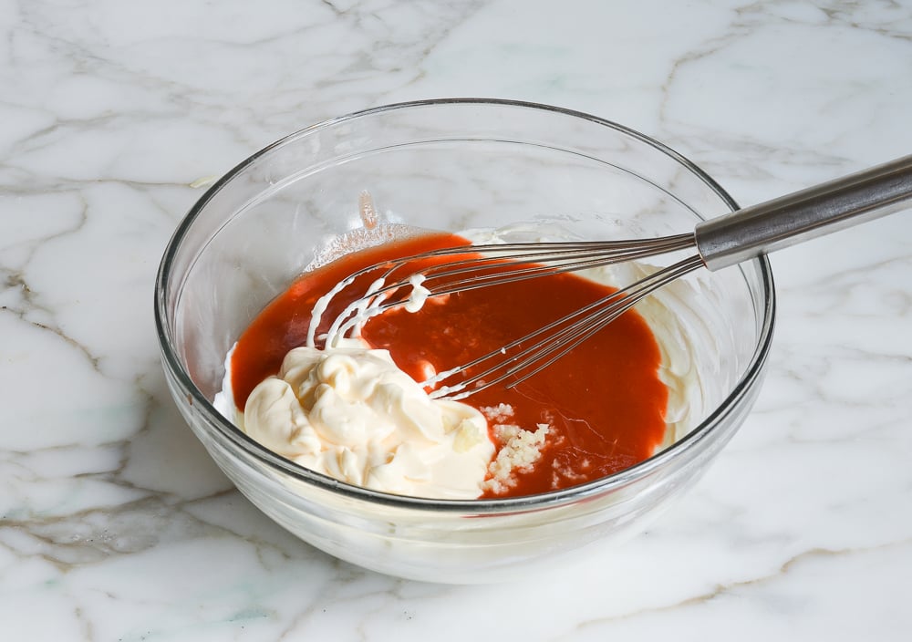 adding the mayonnaise, garlic and hot sauce