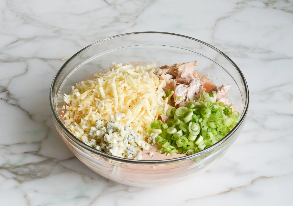 adding the chicken, cheese, and scallions